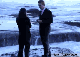 Person proposing when a wave crashes into them and their partner