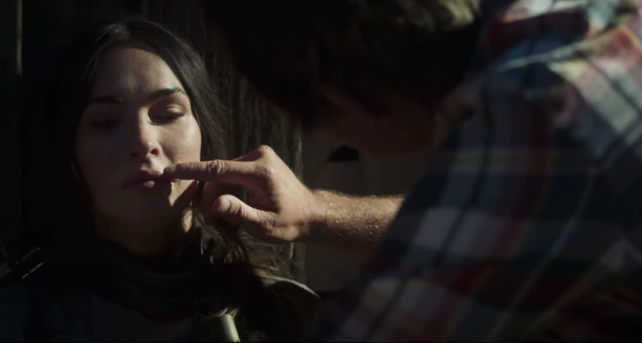 A man touches Megan&#x27;s face while she winces in a screenshot from the film