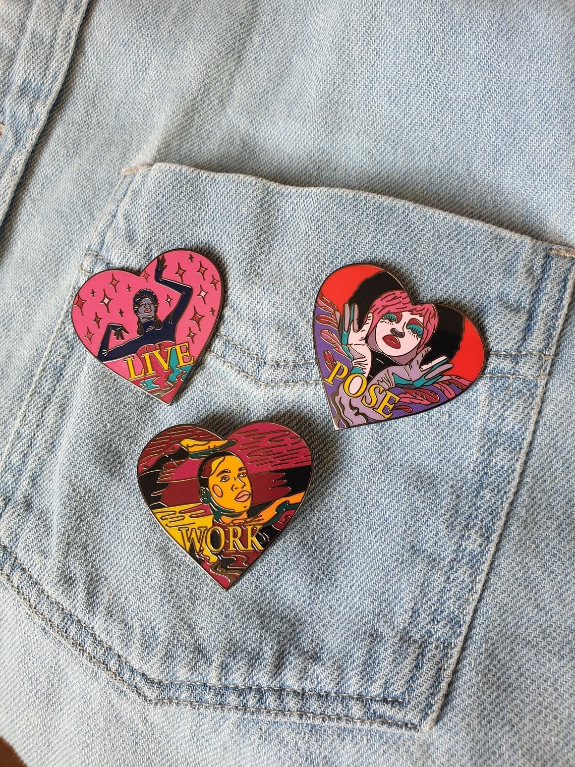 three heart-shaped pins with colorful illustrations of Elektra, Angel, and Damon respectively and they&#x27;re all doing Vogue poses