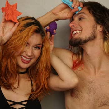Models holding orange star-shaped vibrator, purple squid vibrator and teal fantasy vibrator
