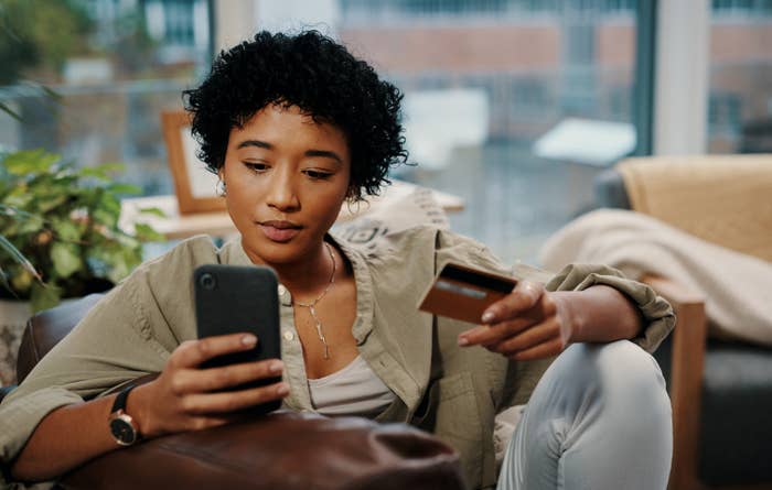 Woman shopping on her phone with a credit card