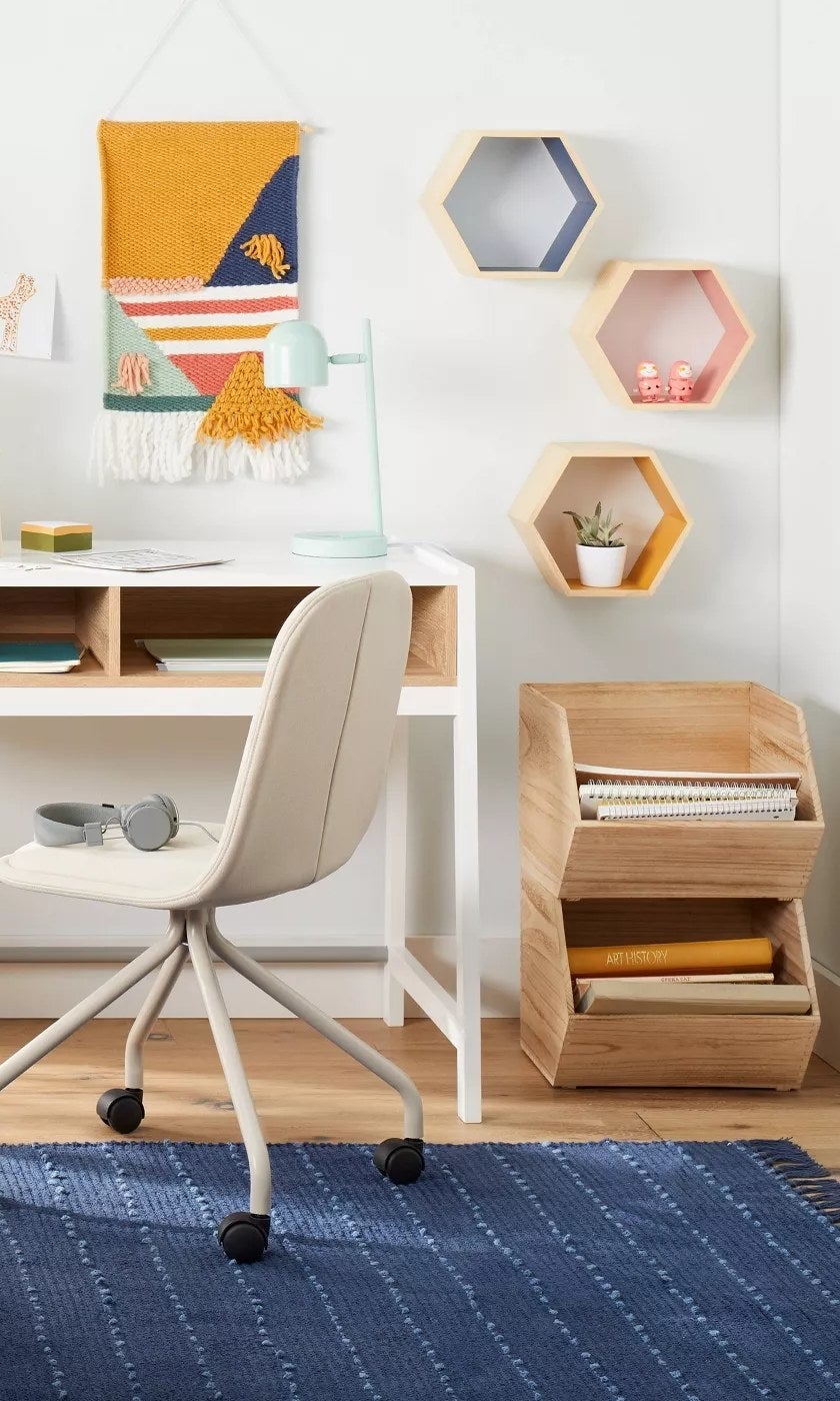 The hexagon-shaped shelves in different colors hanging on an office wall