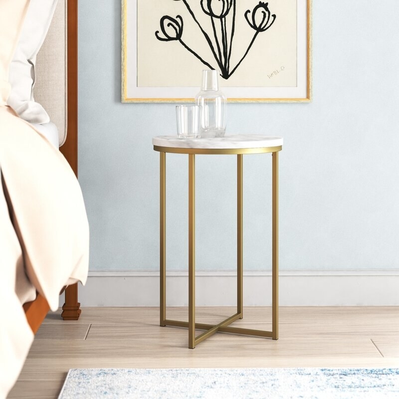 end table with circular marble colored top and gold metal legs