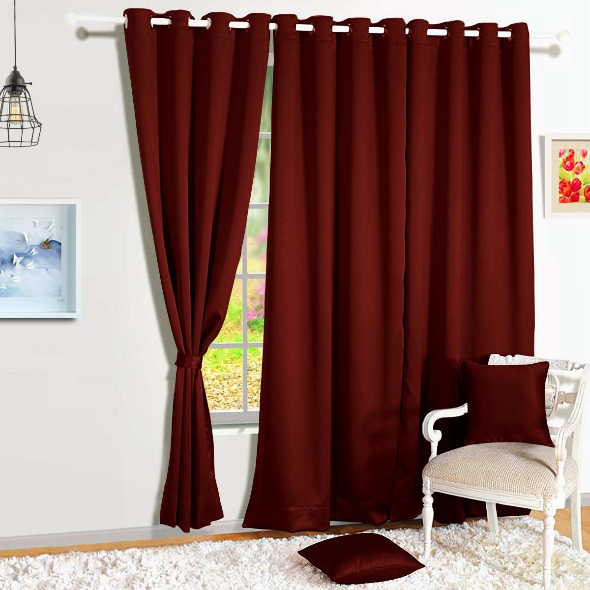 A pair of maroon blackout curtains on a window.