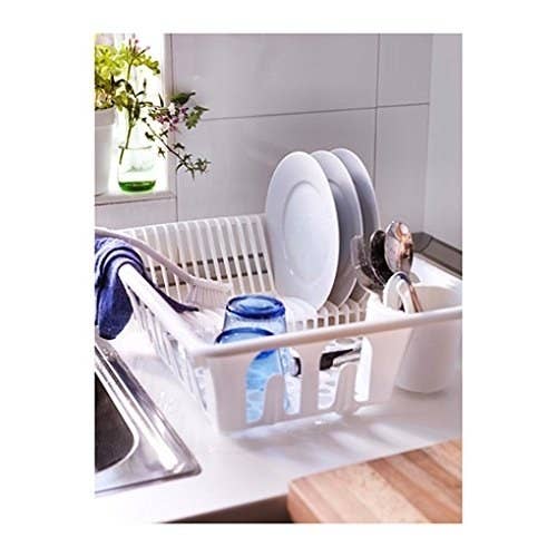 An Ikea dish drying rack with utensils in it 
