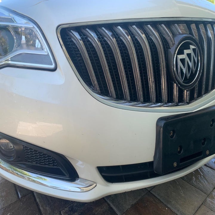 A white car with a clean bumper free of bug guts