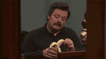 Ron Swanson peeling a banana