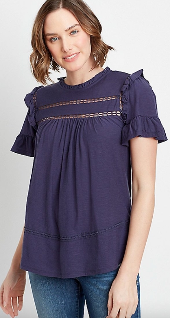 The navy crochet ruffle sleeve top on a model