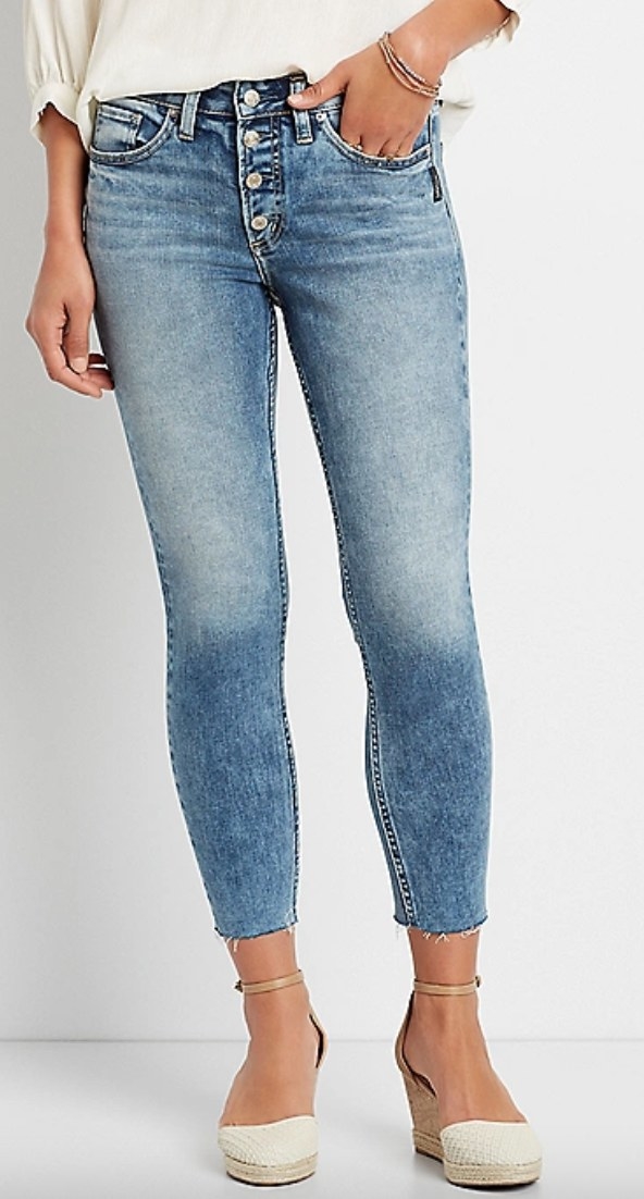 the medium wash cropped jeans on a model