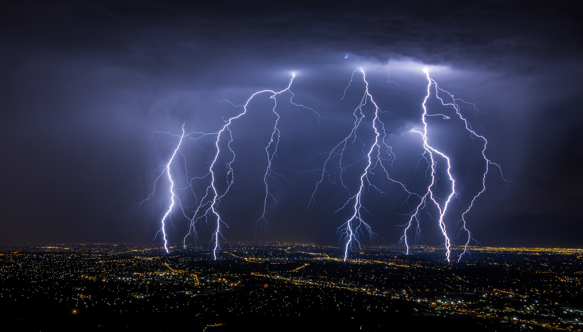 Lightning strikes a city at night