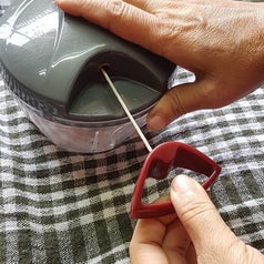 A person pulling on the string to make the chopper work.