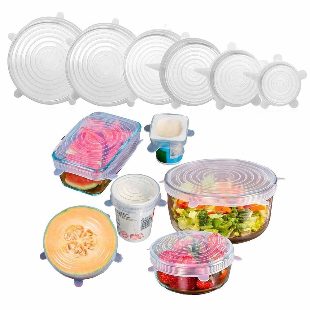 The silicone lids pictured over containers and half-cut fruits.