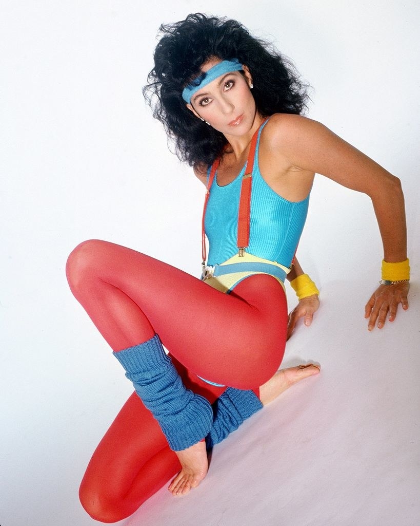 Cher poses for a portrait in athletic clothing in 1984