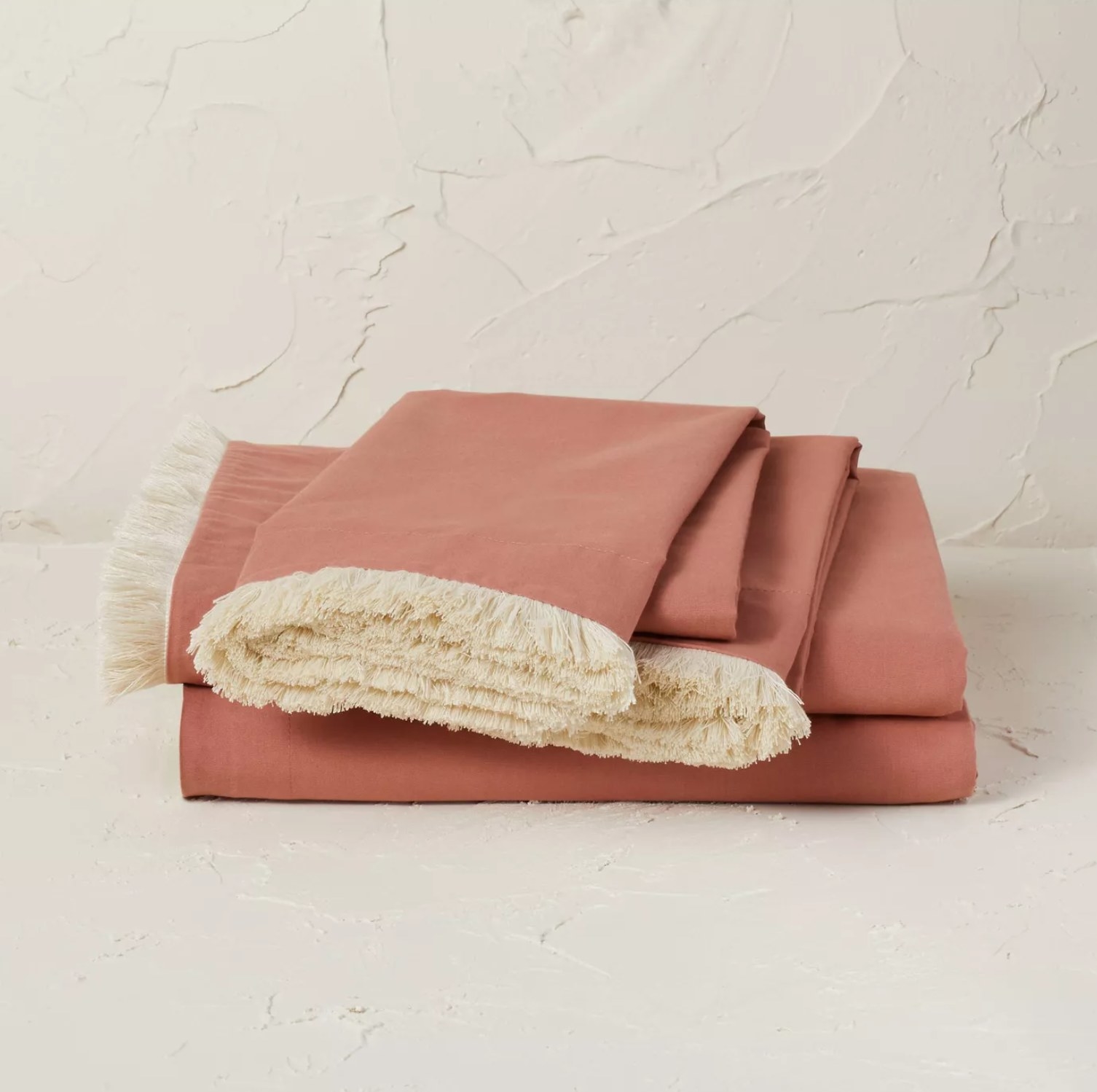 the orange sheets with cream fringe folded