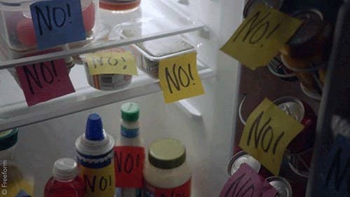 Interior of a refrigerator with post-it notes that say no stuck to all the food