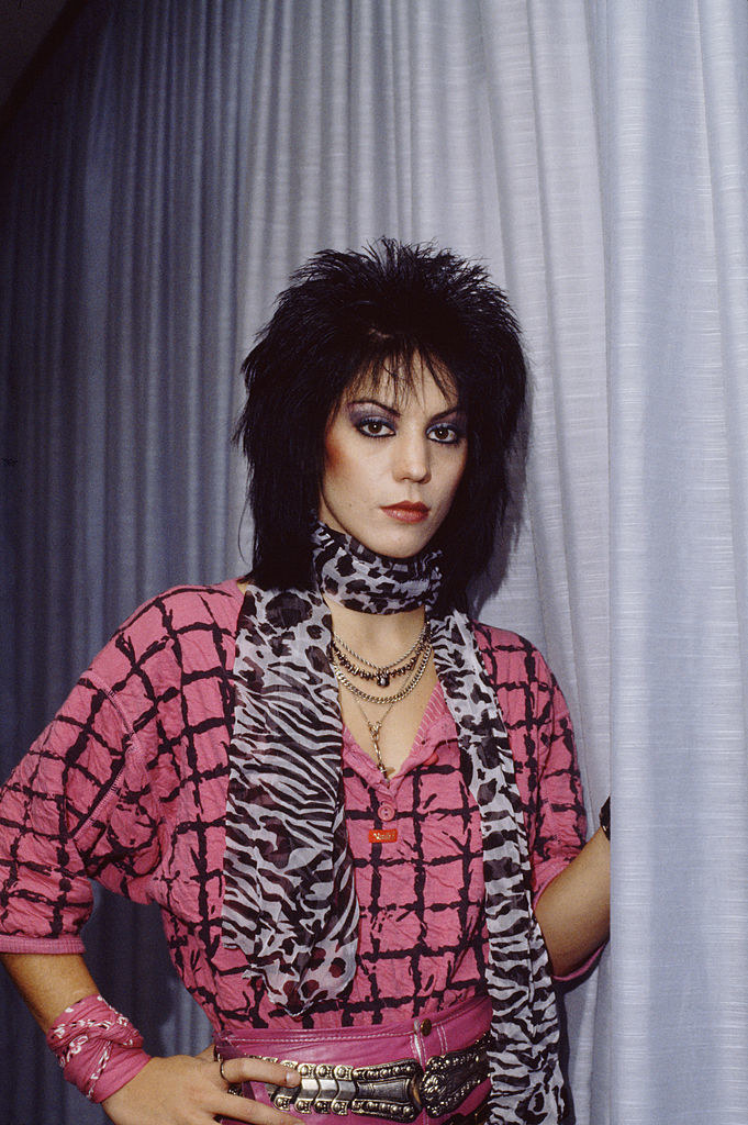 Joan Jett posing for a portrait backstage in 1984