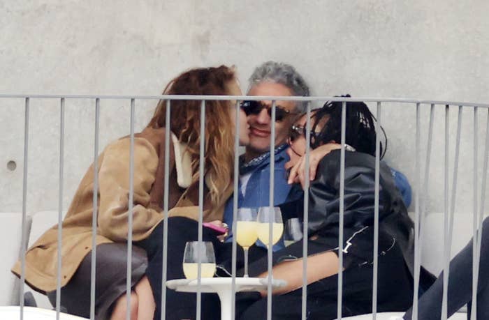 RIta, Taika, and Tessa embracing at a table