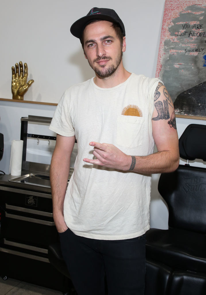 Kendall Schmidt showing off the tattoos on his shoulder
