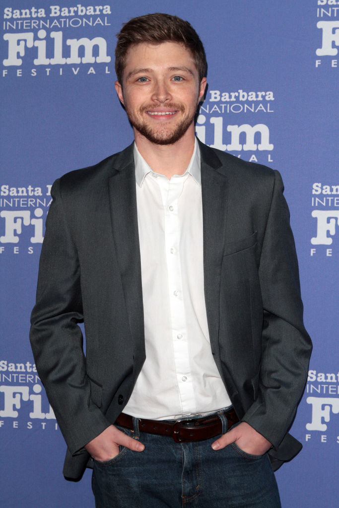 Sterling Knight wearing a sport jacket and jeans at a red carpet