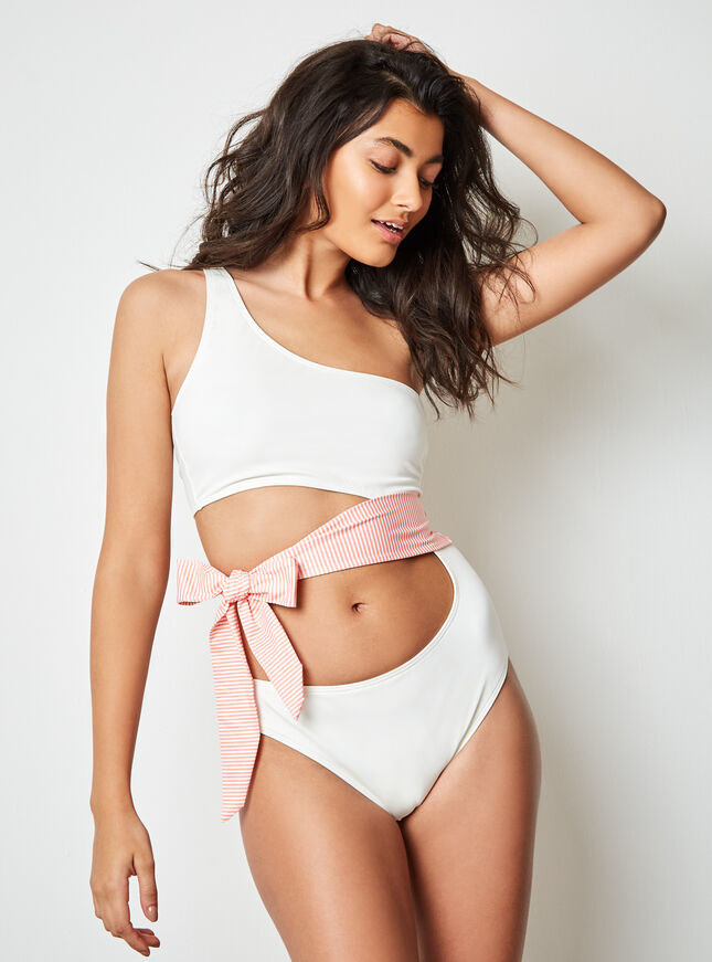 white swimsuit with side cut out by the stomach and a waist pink tie