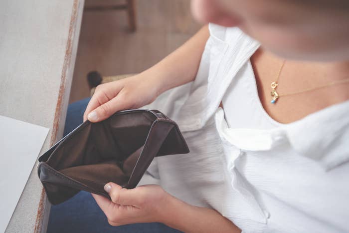 Woman opening an empty wallet