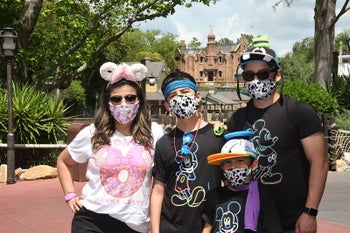 Reviewer's photo showing the family using the cooling towels at Disney