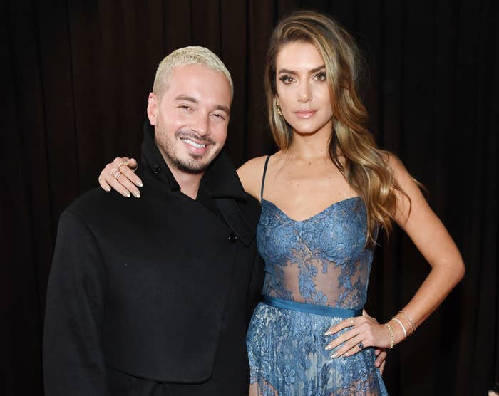 Valentina puts her arm around J Balvin on a red carpet