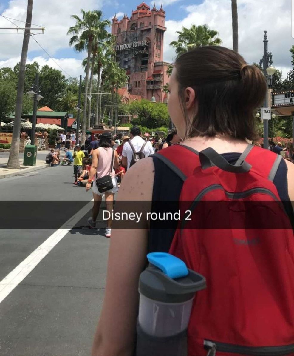 Reviewer wearing the backpack in red at Disney