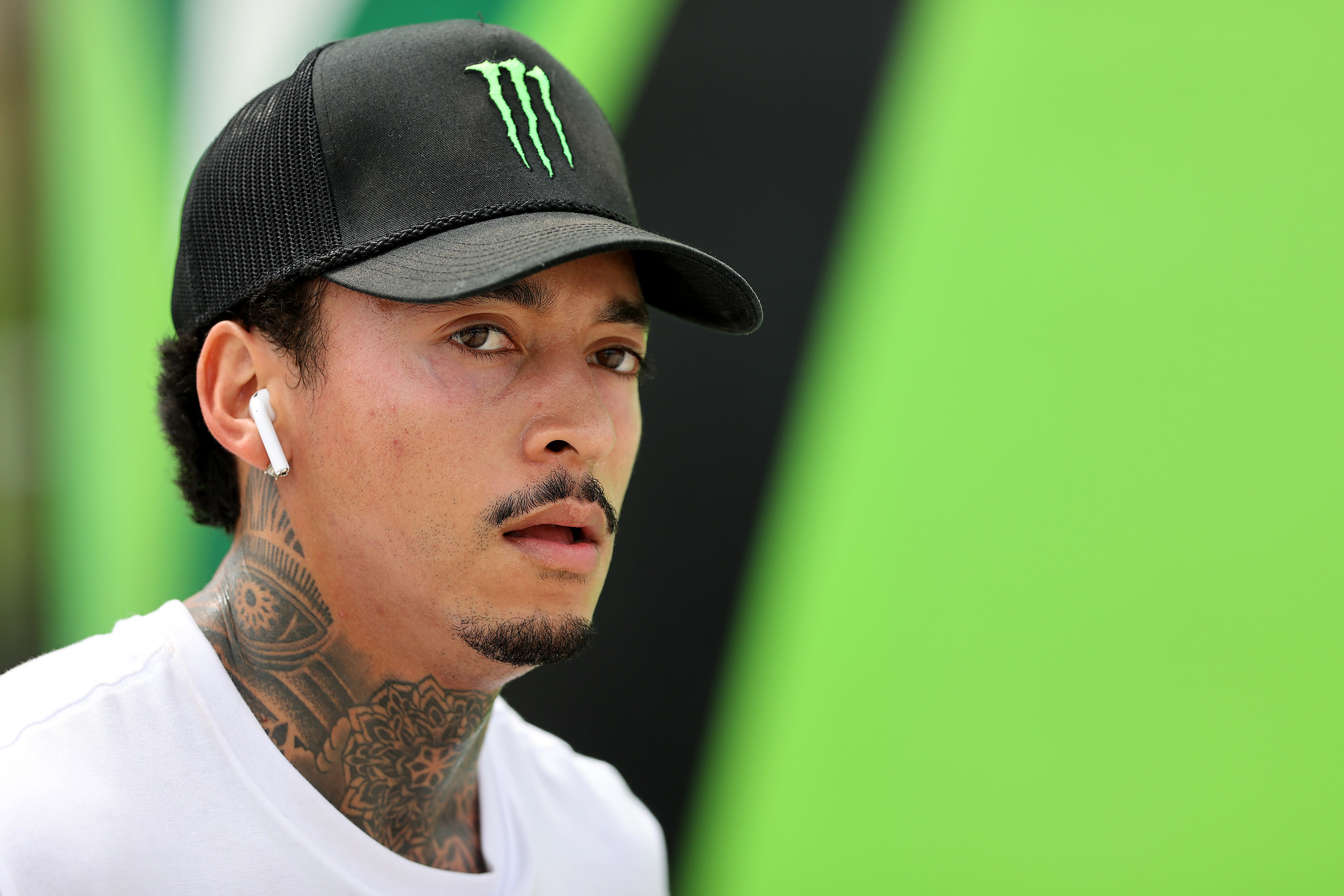 Nyjah Huston in a black-and-green &quot;Monster&quot; hat