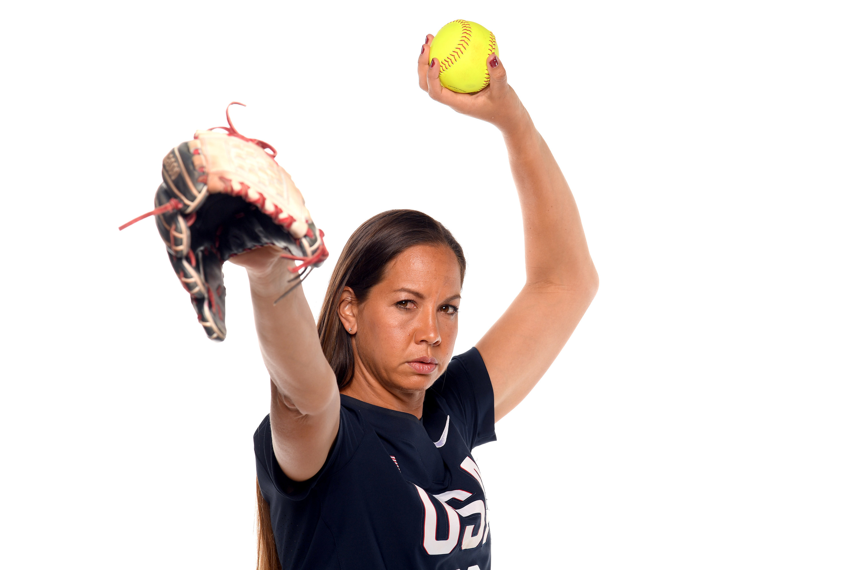 Cat Osterman poses with softball and glove while wearing USA shirt