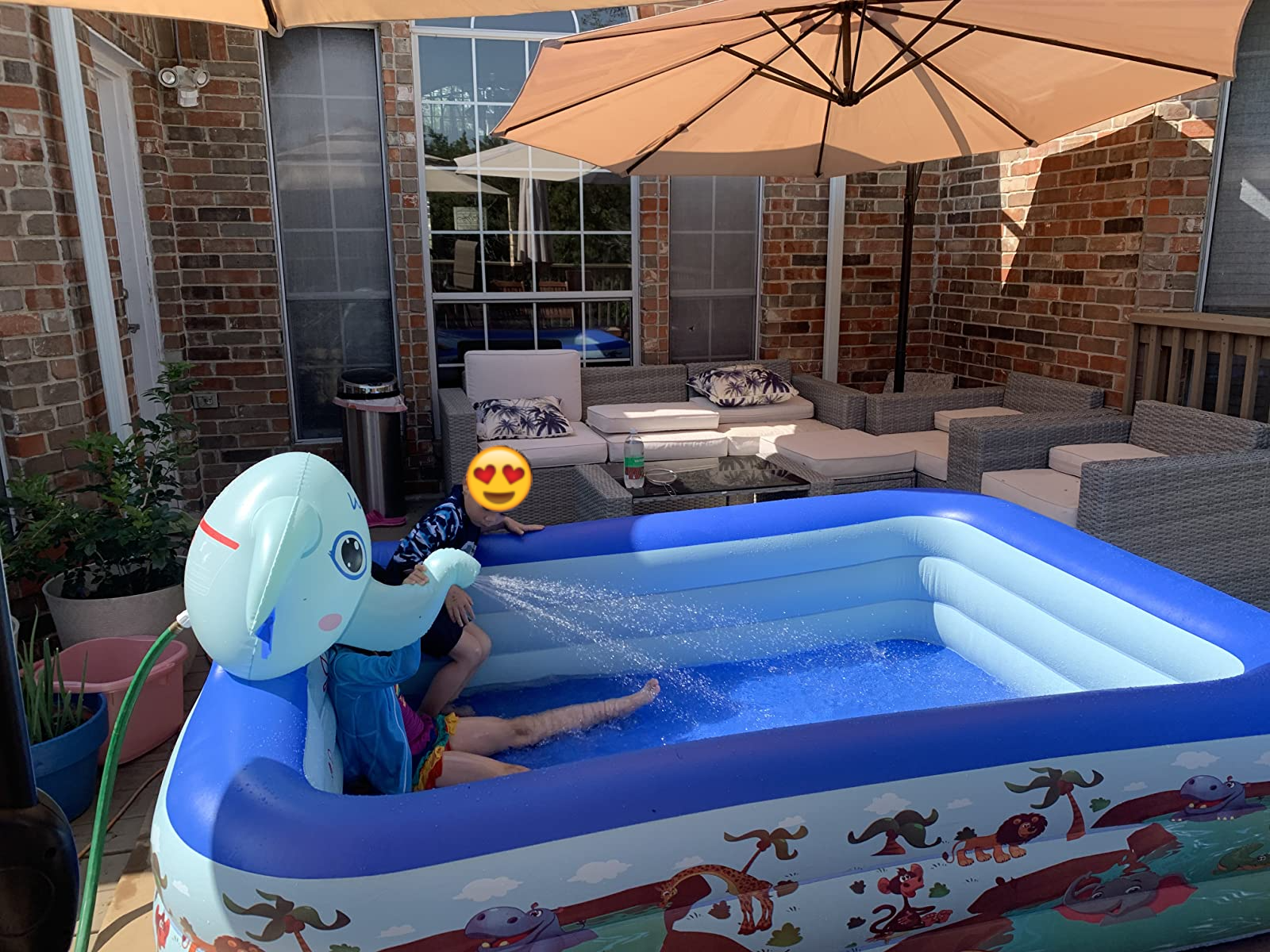 Reviewer&#x27;s photo showing the kids using the pool in their back patio