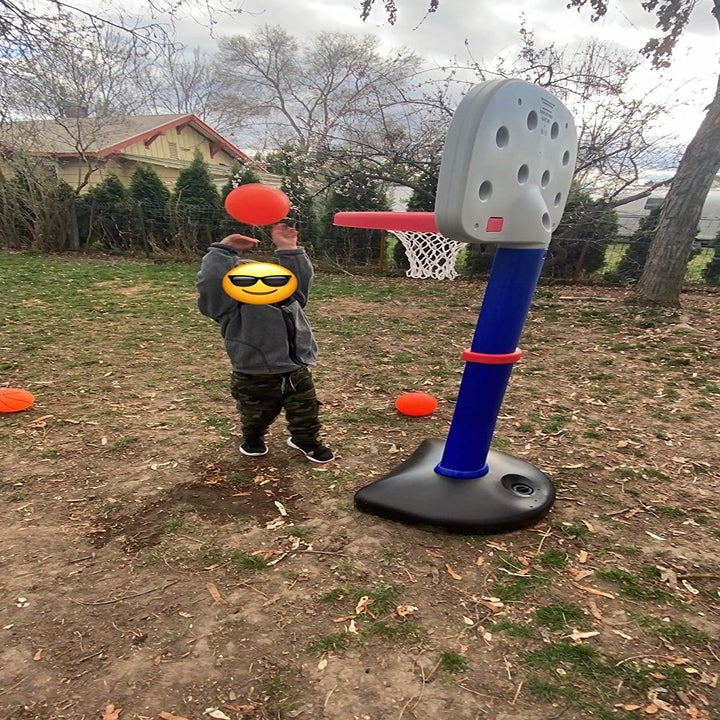Reviewer's photo showing their child dunking a ball through the hoop