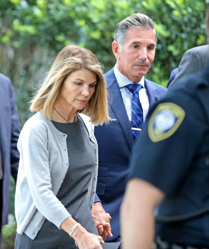 Lori and her husband walking hand-in-hand at the courthouse