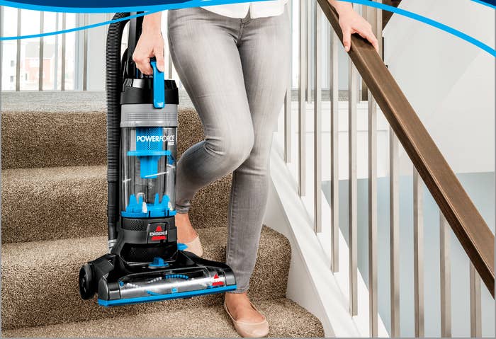 a model carrying the vacuum down a set of stairs