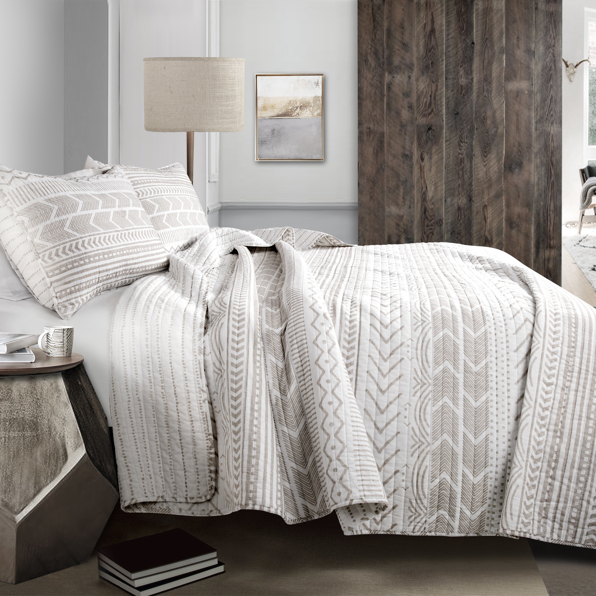 the white and grey patterned comforter on a bed