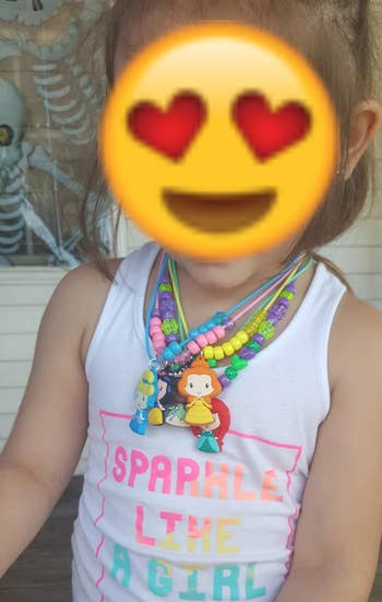 reviewer's kid wearing multiple necklaces from the kit