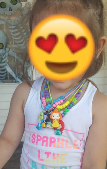 reviewer's kid wearing multiple necklaces from the kit