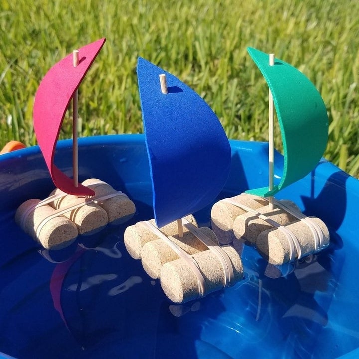 Three cork boats floating in water