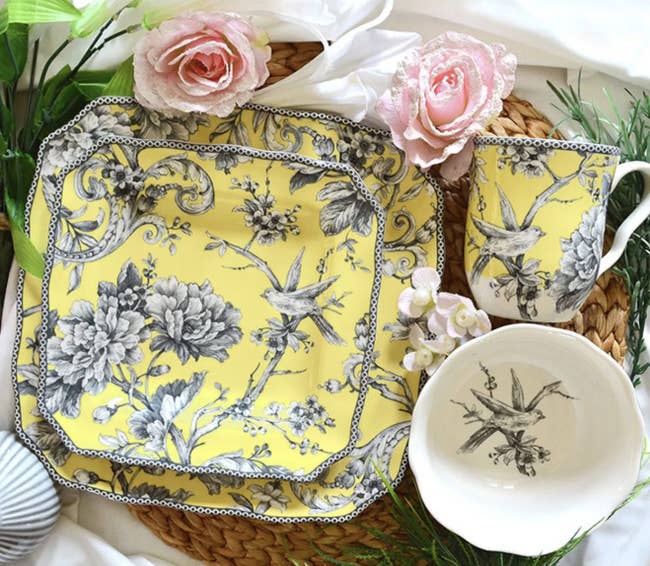 a yellow dish set with grey birds and flowers
