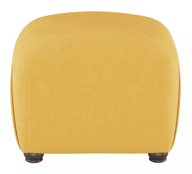 a yellow curved ottoman