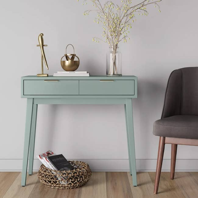a mint green table with two drawers