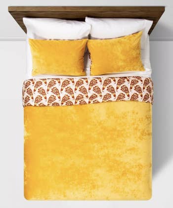 a mustard velvet duvet and sham set on a bed