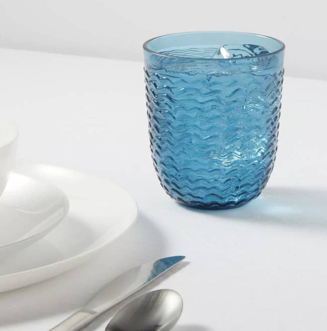 a blue textured tumbler on a table