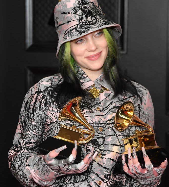 Billie holding two Grammys