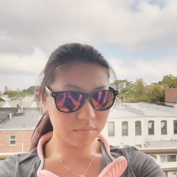 a reviewer wearing the pink fan around their neck