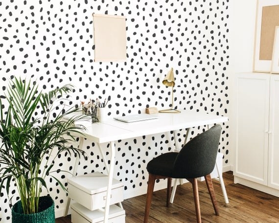 black polka dot peel-and-stick wall decals on wall next to desk