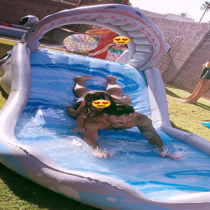 Reviewer and child going down the shark water slide