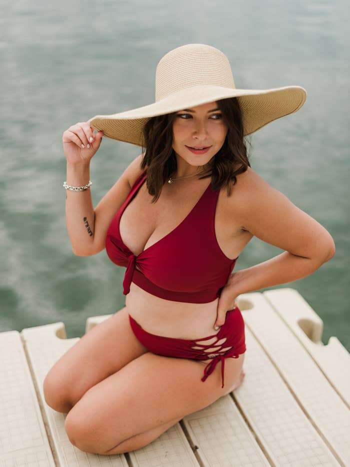 model wearing a ruby red bikini top and a bathing suit bottom
