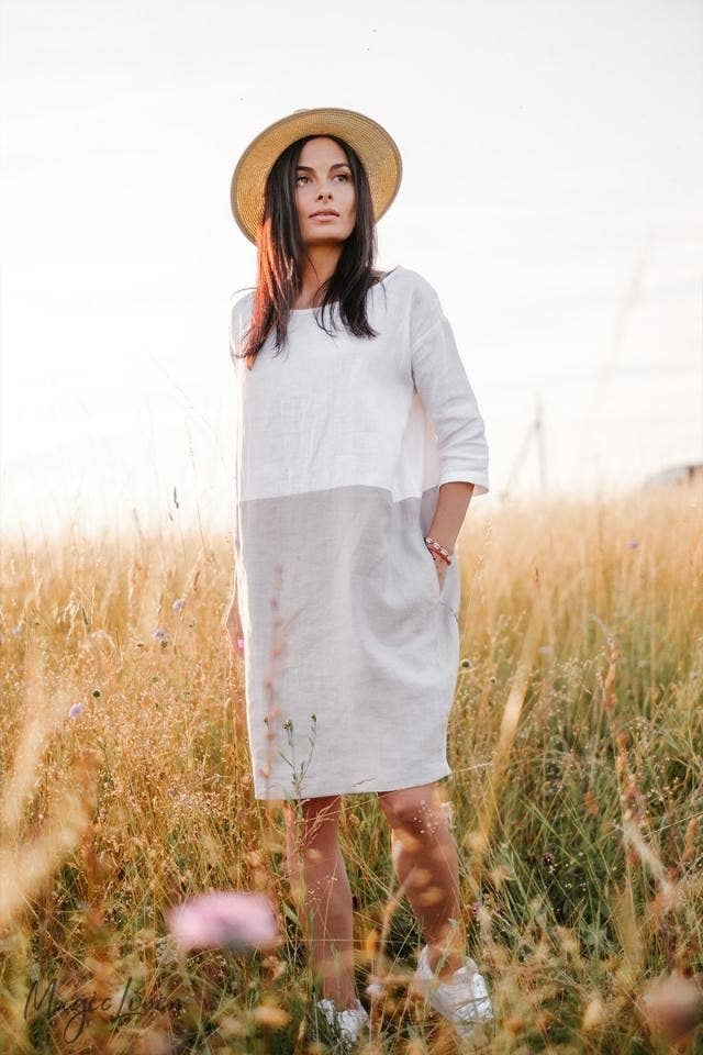 model wearing a gray and white linen dress