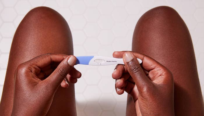 Woman holding pregnancy test